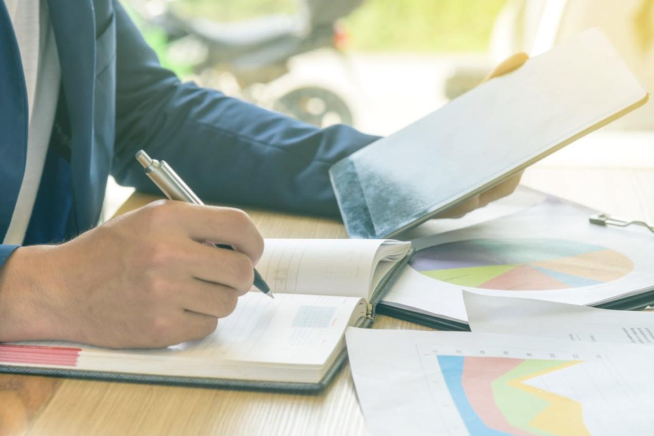 Financial analyst reviewing valuation documentation and certification materials